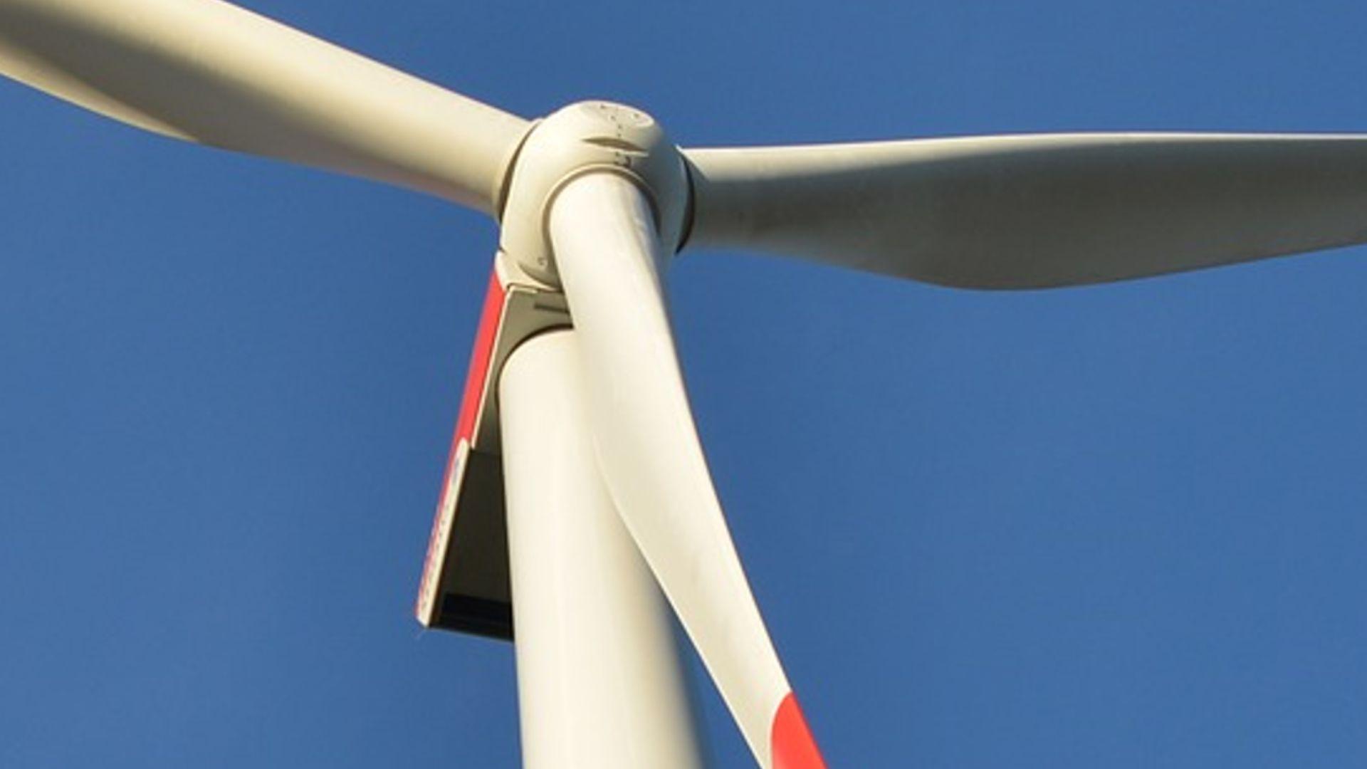 Wind turbine with blue sky.