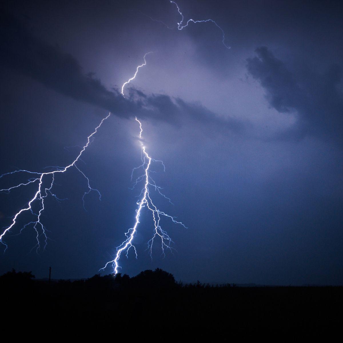 Lightning strike with two strokes and a dark blue sky. Copyright: sandsun/Getty Images